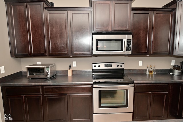 kitchen with stainless steel appliances, dark brown cabinets, dark countertops, and a toaster