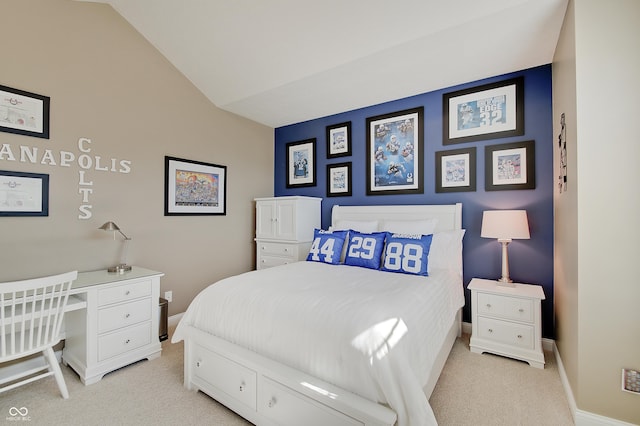 bedroom with lofted ceiling, baseboards, and light carpet