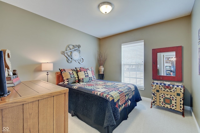 bedroom featuring baseboards and carpet