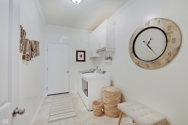 laundry room featuring baseboards, cabinet space, crown molding, and washing machine and clothes dryer