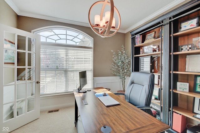 office space with visible vents, carpet floors, a healthy amount of sunlight, and crown molding