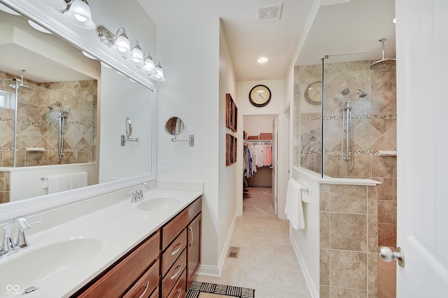 full bath with visible vents, a shower stall, and a sink