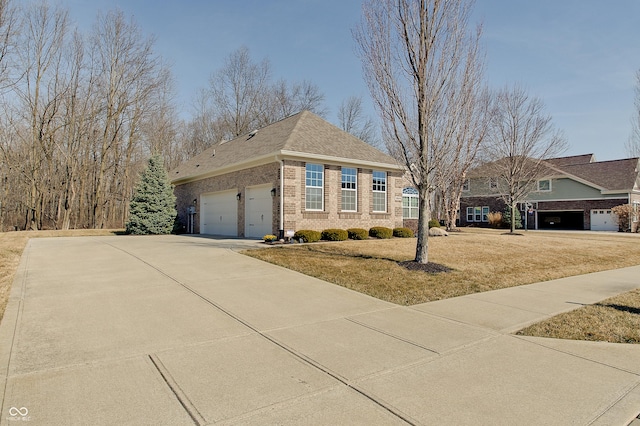 view of front facade featuring brick siding, an attached garage, a shingled roof, a front yard, and driveway