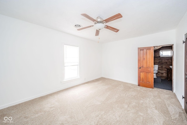 empty room with baseboards, carpet, visible vents, and a ceiling fan