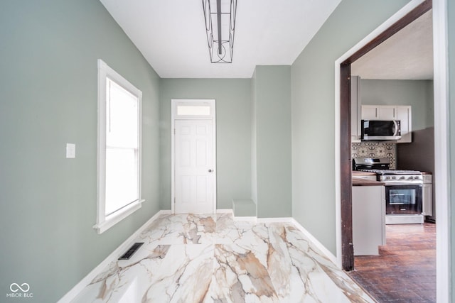 interior space featuring marble finish floor, visible vents, and baseboards