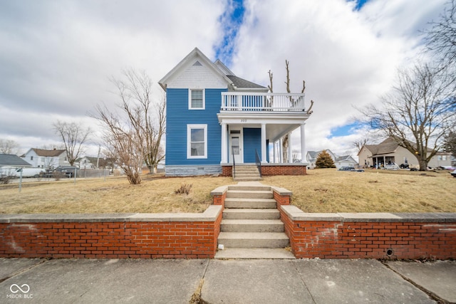 view of front of home with a porch and a balcony