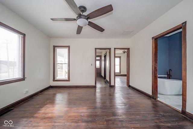 unfurnished room featuring hardwood / wood-style flooring, baseboards, and a wealth of natural light