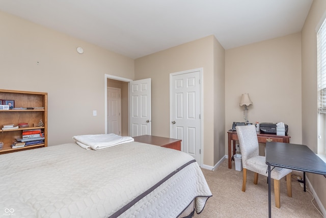 bedroom with light carpet and baseboards