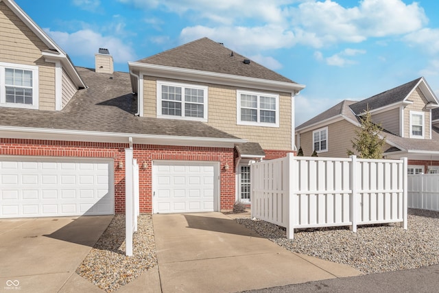 view of front of property featuring a shingled roof, fence, concrete driveway, and brick siding