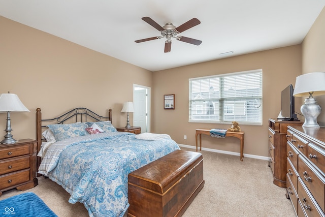 bedroom featuring light carpet, visible vents, baseboards, and a ceiling fan