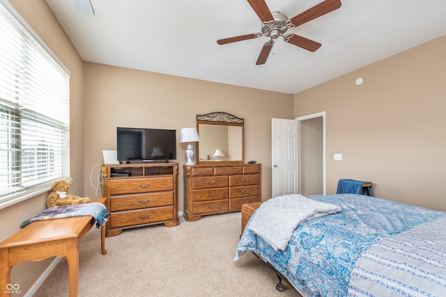 bedroom featuring light carpet and ceiling fan