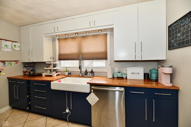 kitchen with a sink, wood counters, white cabinetry, and dishwasher