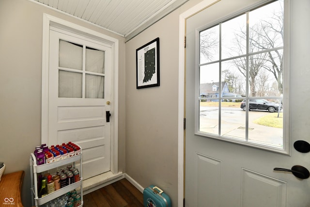 entryway featuring dark wood-type flooring and baseboards