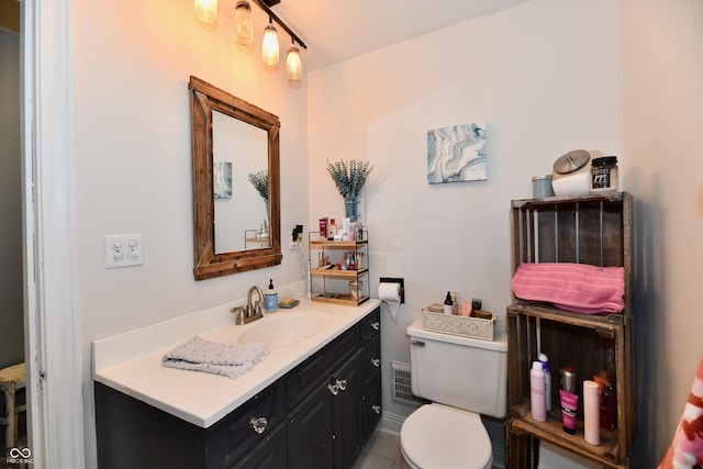 bathroom featuring toilet and vanity