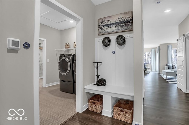 laundry room with laundry area, baseboards, dark wood-style floors, and washing machine and clothes dryer