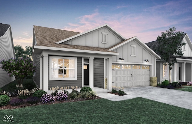 view of front of house featuring a shingled roof, a lawn, concrete driveway, an attached garage, and board and batten siding