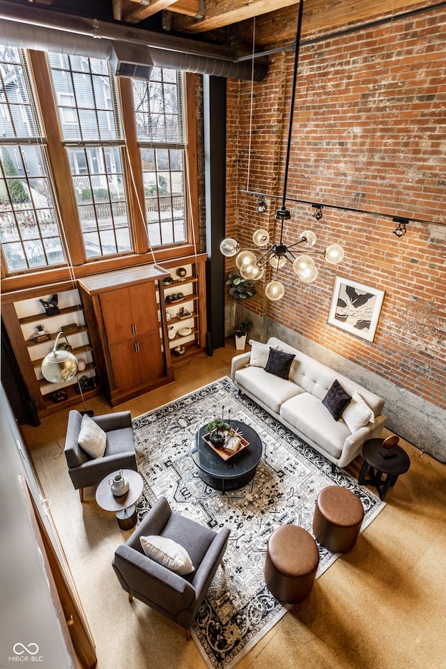 sunken living room featuring a wealth of natural light and brick wall