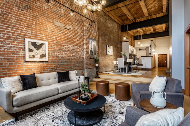 living room with brick wall, wood ceiling, beamed ceiling, a high ceiling, and a notable chandelier