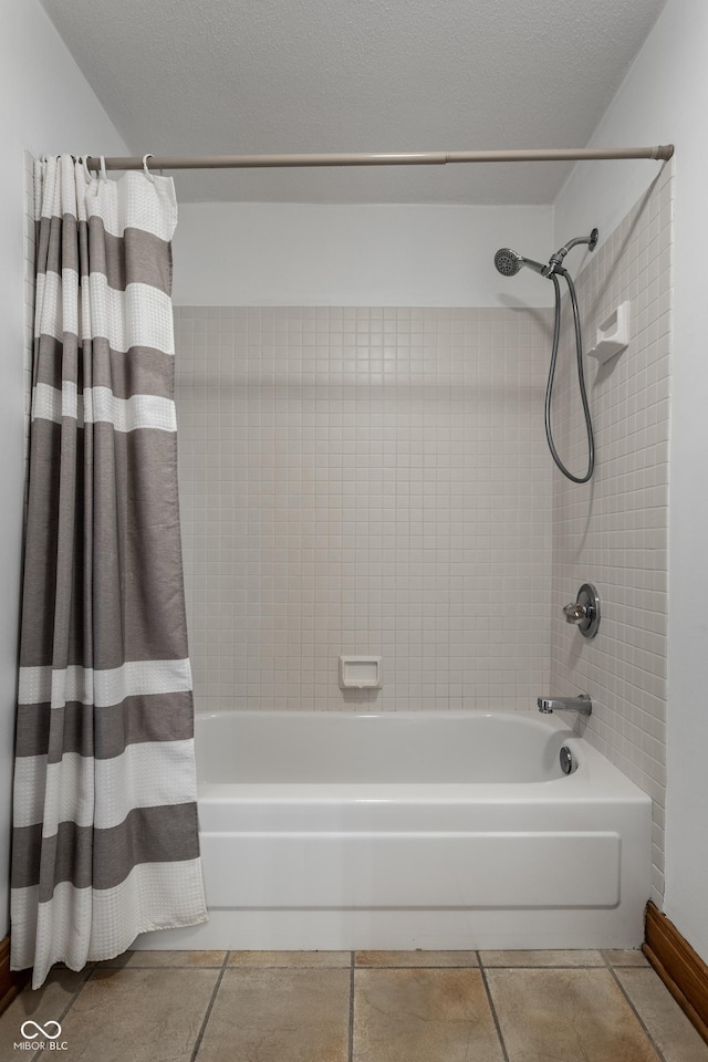 bathroom with shower / tub combo, tile patterned flooring, and a textured ceiling