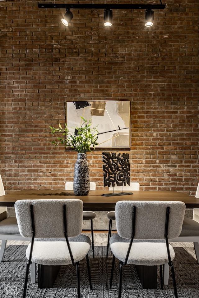 dining room with brick wall