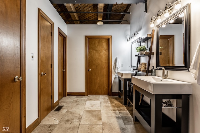 full bath with wood ceiling, baseboards, beamed ceiling, and stone tile floors