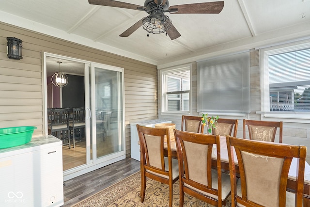 sunroom with ceiling fan with notable chandelier