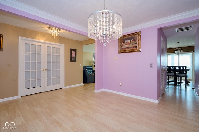 unfurnished dining area featuring a chandelier, french doors, visible vents, and light wood finished floors