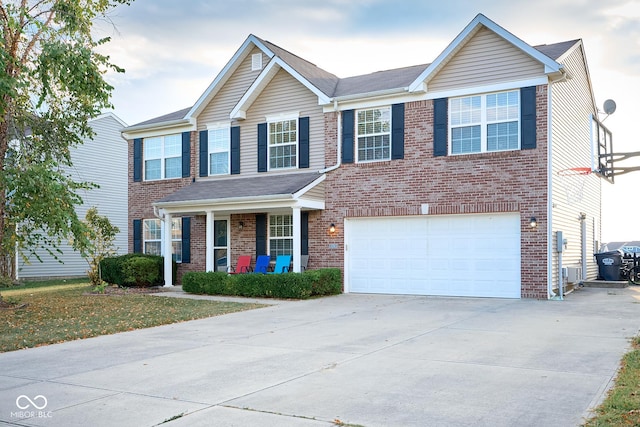 view of front of property featuring a garage, concrete driveway, and brick siding