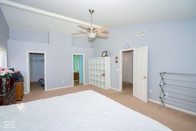 bedroom with visible vents, baseboards, vaulted ceiling, a spacious closet, and carpet