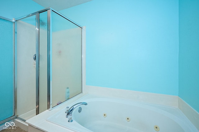 full bath with a stall shower and a whirlpool tub