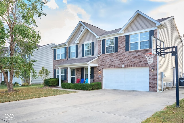 view of front facade with an attached garage, a front yard, concrete driveway, and brick siding