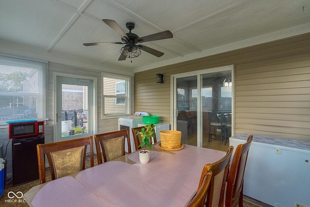 sunroom / solarium with a ceiling fan