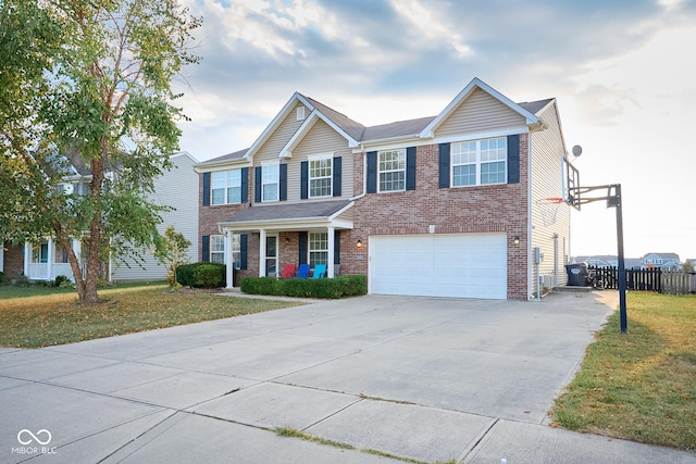 view of front of home featuring a front yard, concrete driveway, brick siding, and fence