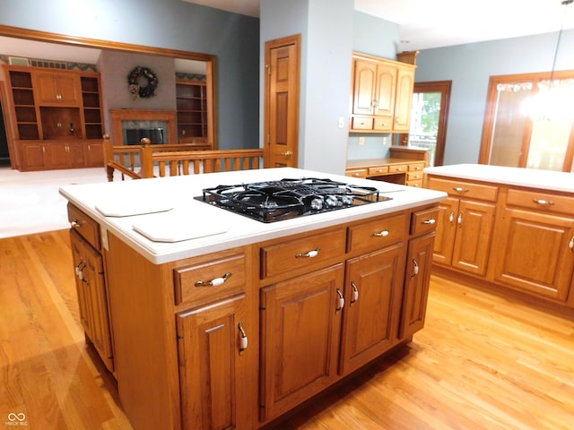 1229 E Tara Rd, Greensburg, IN 47240 - kitchen featuring black gas cooktop, a center island, light wood-type flooring, and light countertops