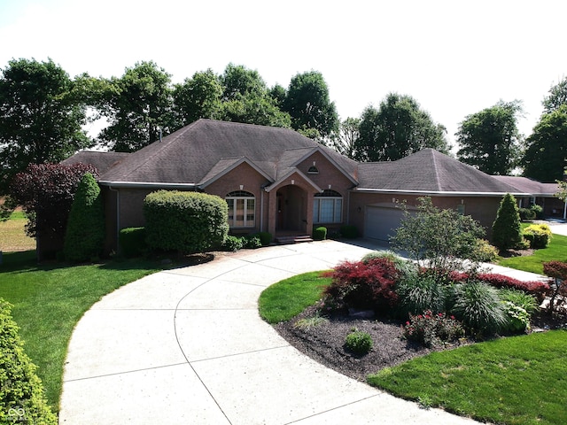 1229 E Tara Rd, Greensburg, IN 47240 - ranch-style house with a garage, driveway, and a front yard