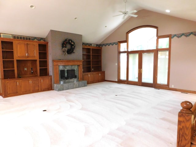1229 E Tara Rd, Greensburg, IN 47240 - unfurnished living room with french doors, a ceiling fan, light carpet, a premium fireplace, and high vaulted ceiling