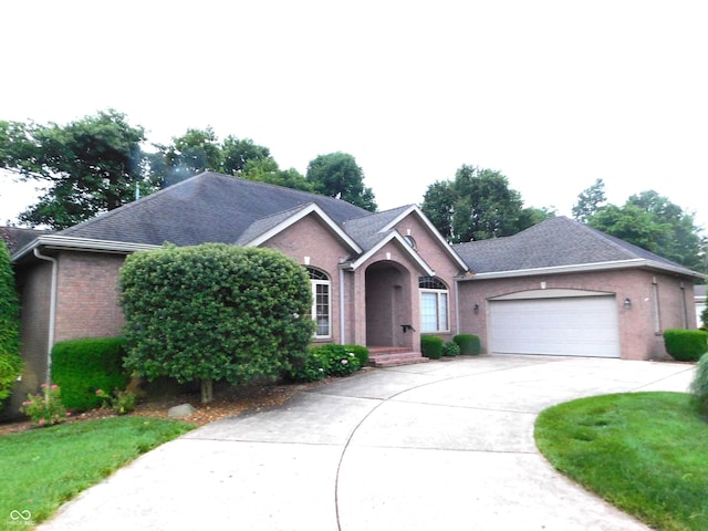1229 E Tara Rd, Greensburg, IN 47240 - ranch-style house featuring brick siding, an attached garage, and concrete driveway