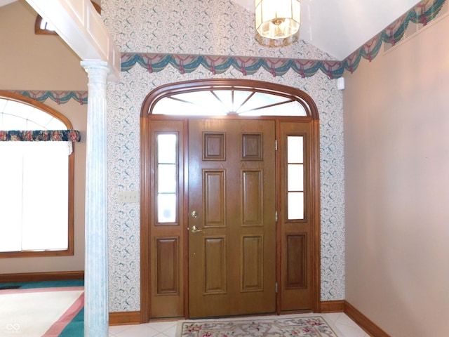 1229 E Tara Rd, Greensburg, IN 47240 - foyer entrance featuring wallpapered walls, tile patterned flooring, ornate columns, and lofted ceiling