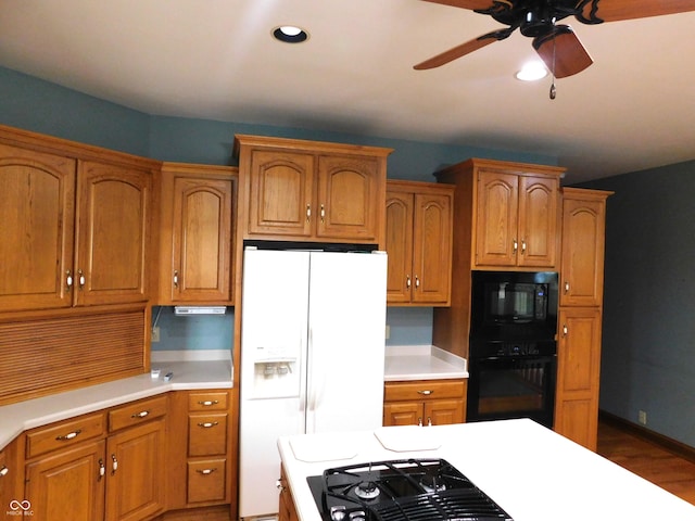 1229 E Tara Rd, Greensburg, IN 47240 - kitchen with black appliances, light countertops, ceiling fan, brown cabinets, and recessed lighting