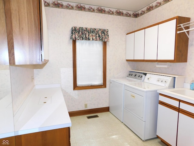 1229 E Tara Rd, Greensburg, IN 47240 - washroom with cabinet space, washing machine and clothes dryer, wallpapered walls, and light floors
