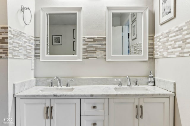 full bath featuring a sink and double vanity