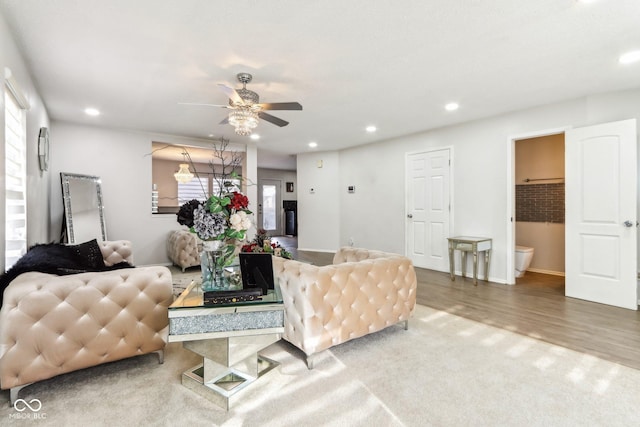 living room featuring a ceiling fan, recessed lighting, and wood finished floors