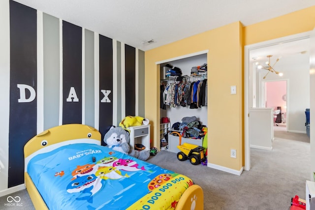 carpeted bedroom with visible vents, baseboards, and a closet