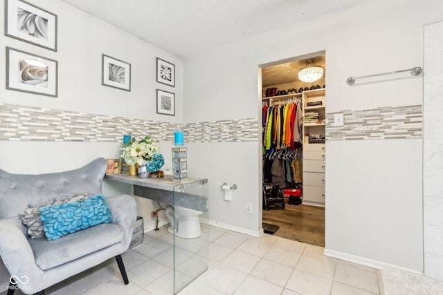 interior space with tile patterned flooring and a walk in closet