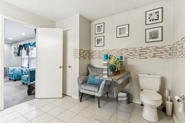 bathroom featuring tile patterned flooring and toilet