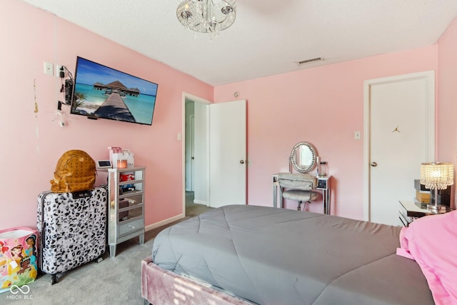 carpeted bedroom featuring a chandelier, visible vents, and baseboards