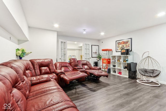 living room featuring baseboards, wood finished floors, and recessed lighting