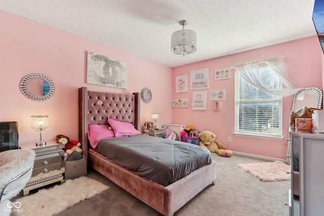 carpeted bedroom featuring a textured ceiling and baseboards