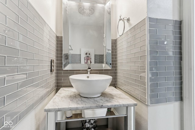 bathroom featuring tasteful backsplash and vanity