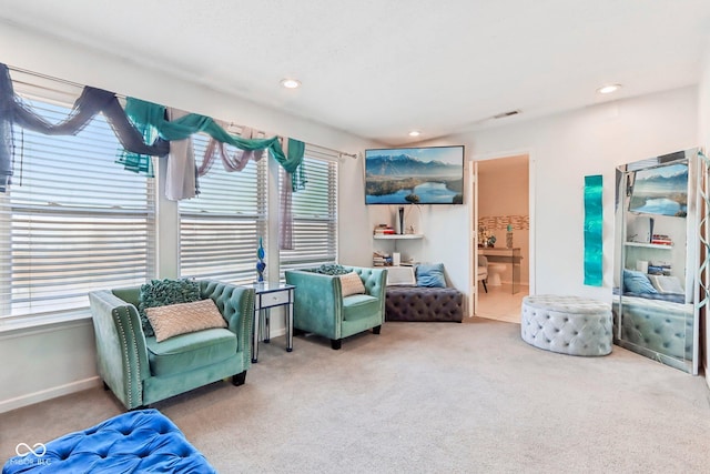 living area with carpet, visible vents, baseboards, and recessed lighting